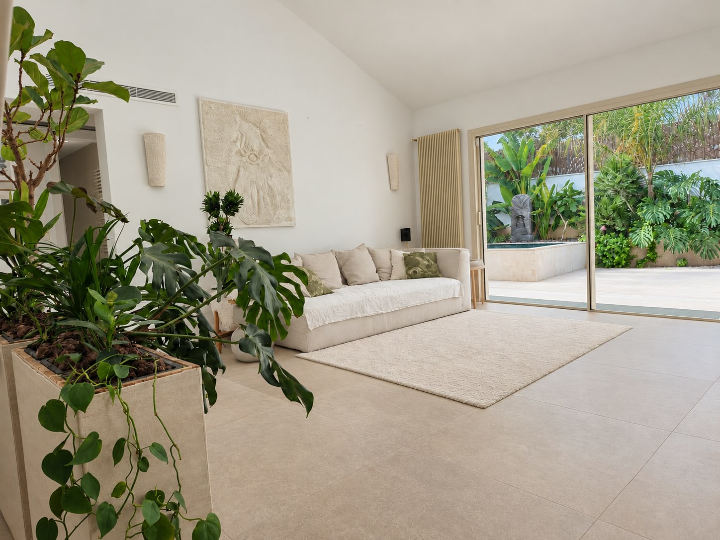 Living room opening directly onto the landscaped courtyard